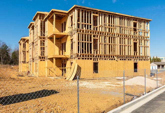 a close-up of temporary chain link fences enclosing a construction site, signaling progress in the project's development in Escondido CA